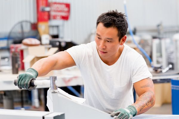 portrait of asian worker in production plant working on the factory floor