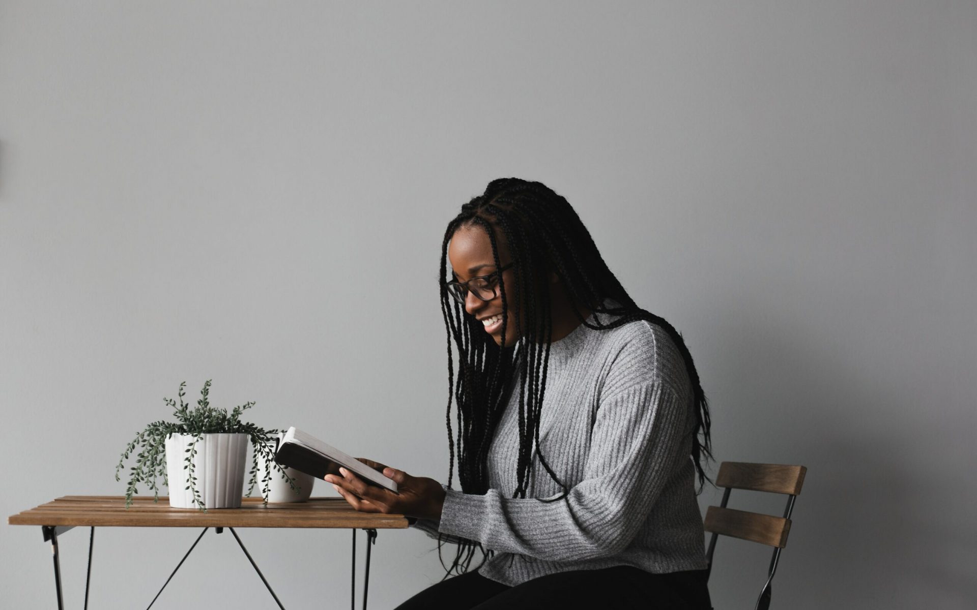 woman in white and black striped long sleeve shirt sitting on chair