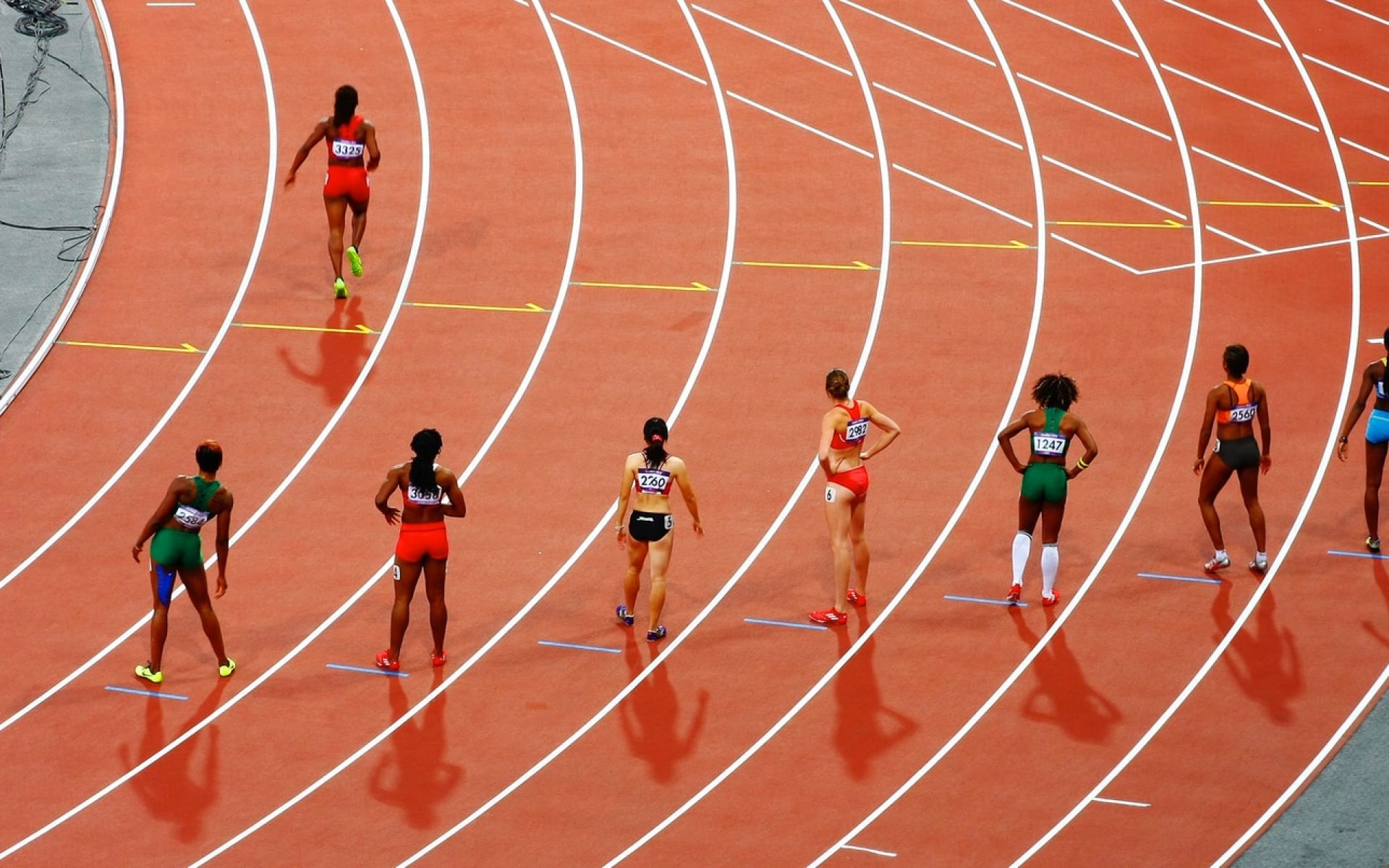 women running on race track during daytime